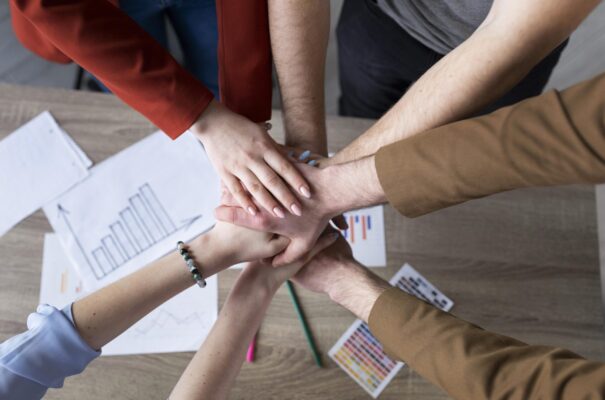 group-coworkers-putting-their-hands-together group-coworkers-putting-their-hands-together