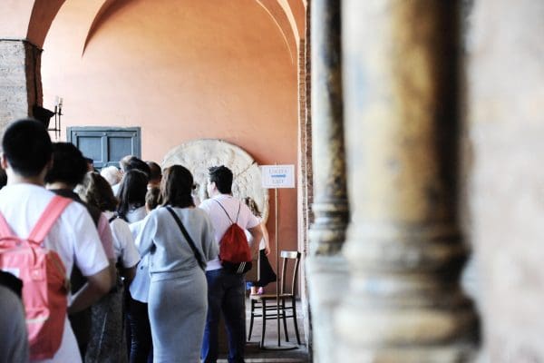Rome, Italy – October 10, 2018: Visitors waiting to see the mouth of truth (Bocca della Verità). It attracts visitors who audaciously stick their hand in the mouth. Church of Santa Maria in Cosmedin in Rome, Italy